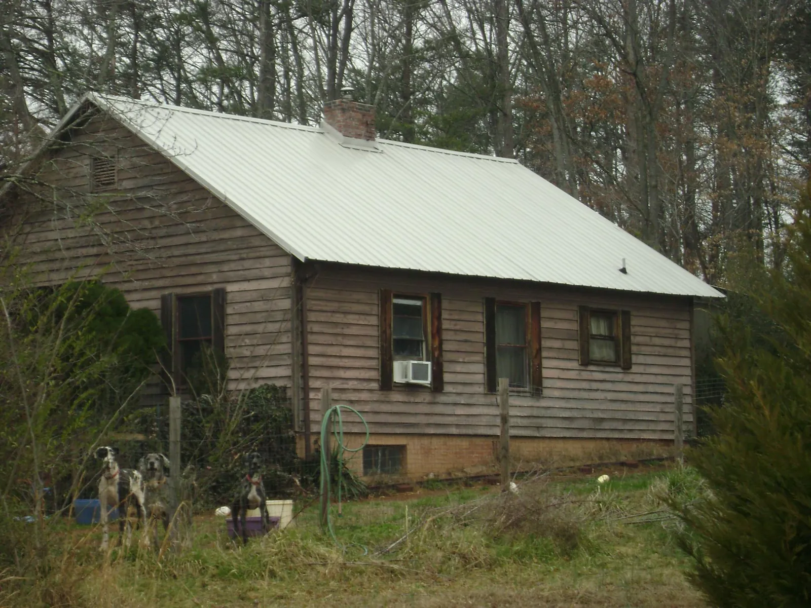 White metal roof on an old wood sided farmhouse, from a Metal Roof Installation job in Coal City